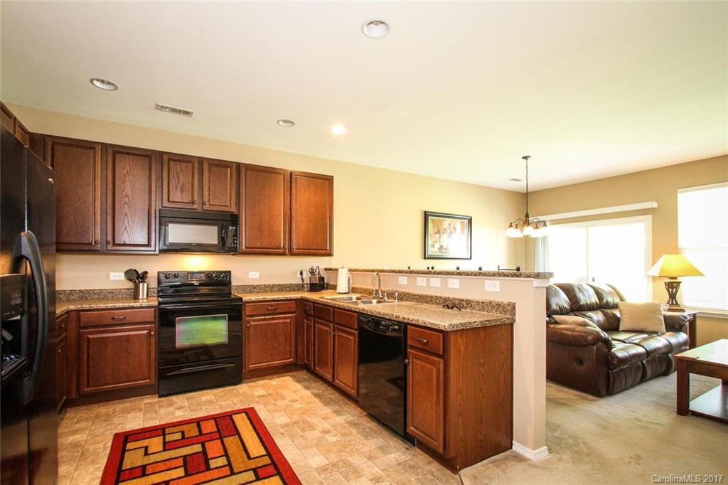 219 River Clay Road Fort Mill, SC 29708 - Photo 12 of 24 a kitchen with stainless steel appliances granite countertop a stove top oven a sink dishwasher and cabinets with wooden floor