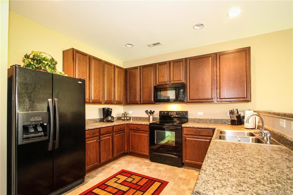 219 River Clay Road Fort Mill, SC 29708 - Photo 13 of 24 a kitchen with stainless steel appliances granite countertop a refrigerator stove top oven and sink