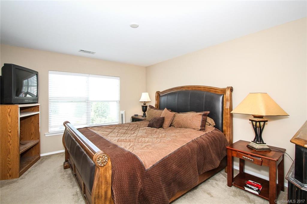 219 River Clay Road Fort Mill, SC 29708 - Photo 19 of 24 a bedroom with a bed and a fireplace