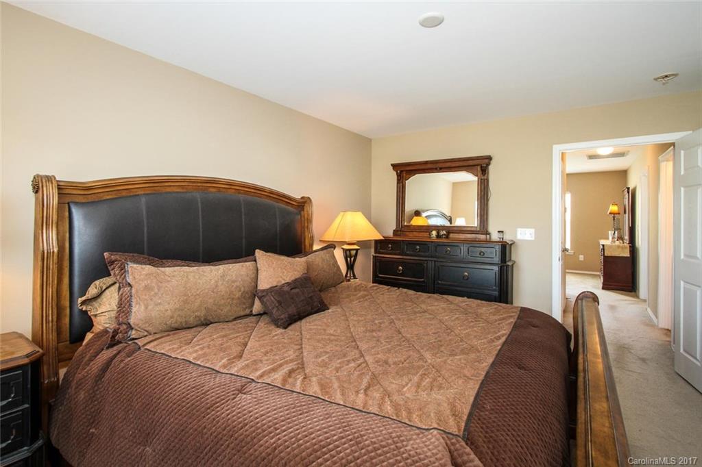 219 River Clay Road Fort Mill, SC 29708 - Photo 20 of 24 a bedroom with a bed and a lamp on dresser