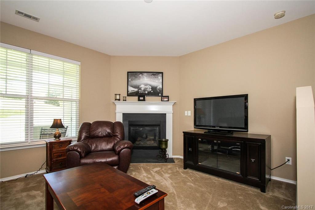219 River Clay Road Fort Mill, SC 29708 - Photo 6 of 24 a living room with furniture a fireplace and a flat screen tv