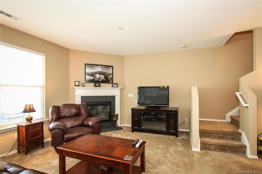 219 River Clay Road Fort Mill, SC 29708 - Photo 8 of 24 a living room with furniture a fireplace and a flat screen tv