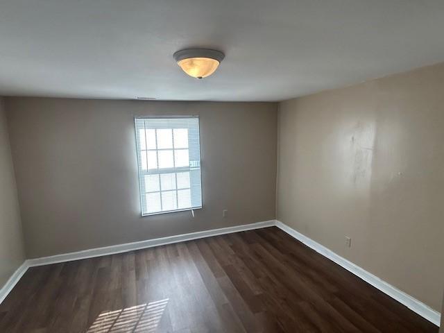 714 Blount Street Smithfield, NC 27577 - Photo 7 of 13 a view of an empty room with wooden floor and a window