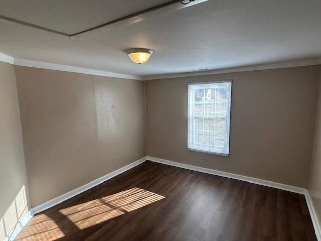 714 Blount Street Smithfield, NC 27577 - Photo 8 of 13 an empty room with wooden floor and windows