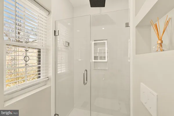 a bathroom with a shower and a window