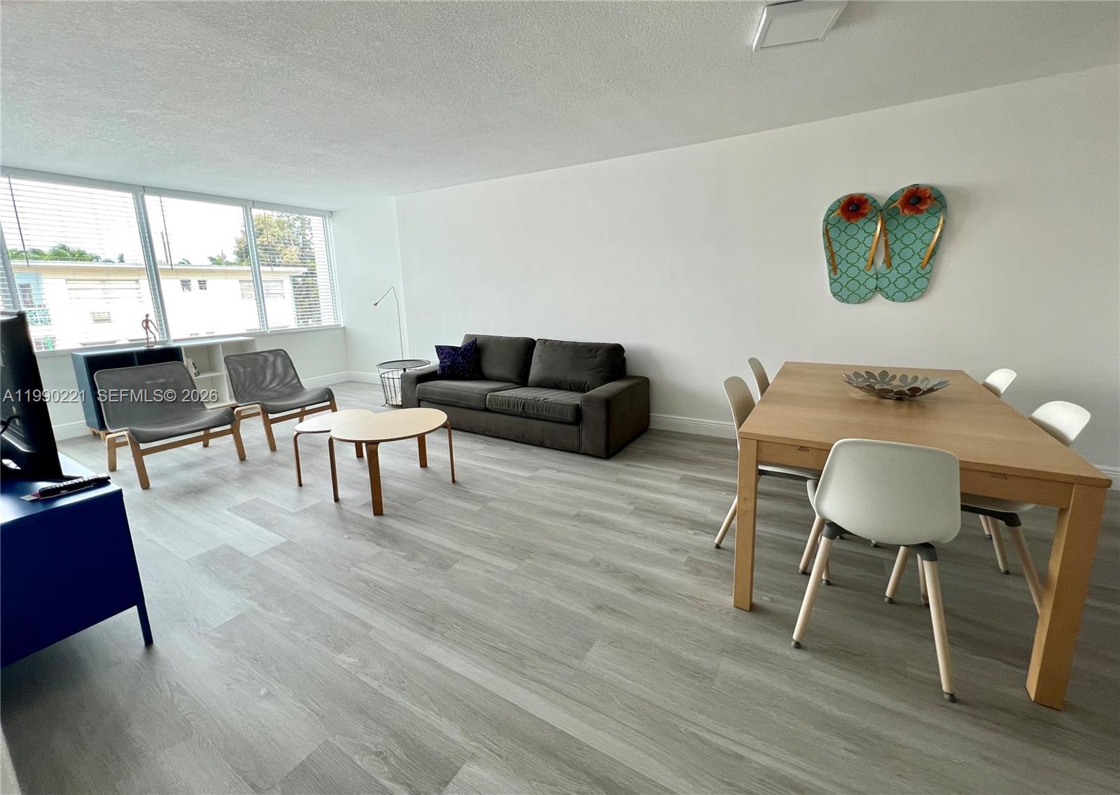 8233 Harding Avenue, Unit 204 Miami Beach, FL 33141 - Photo 11 of 18 a living room with furniture and a wooden floor