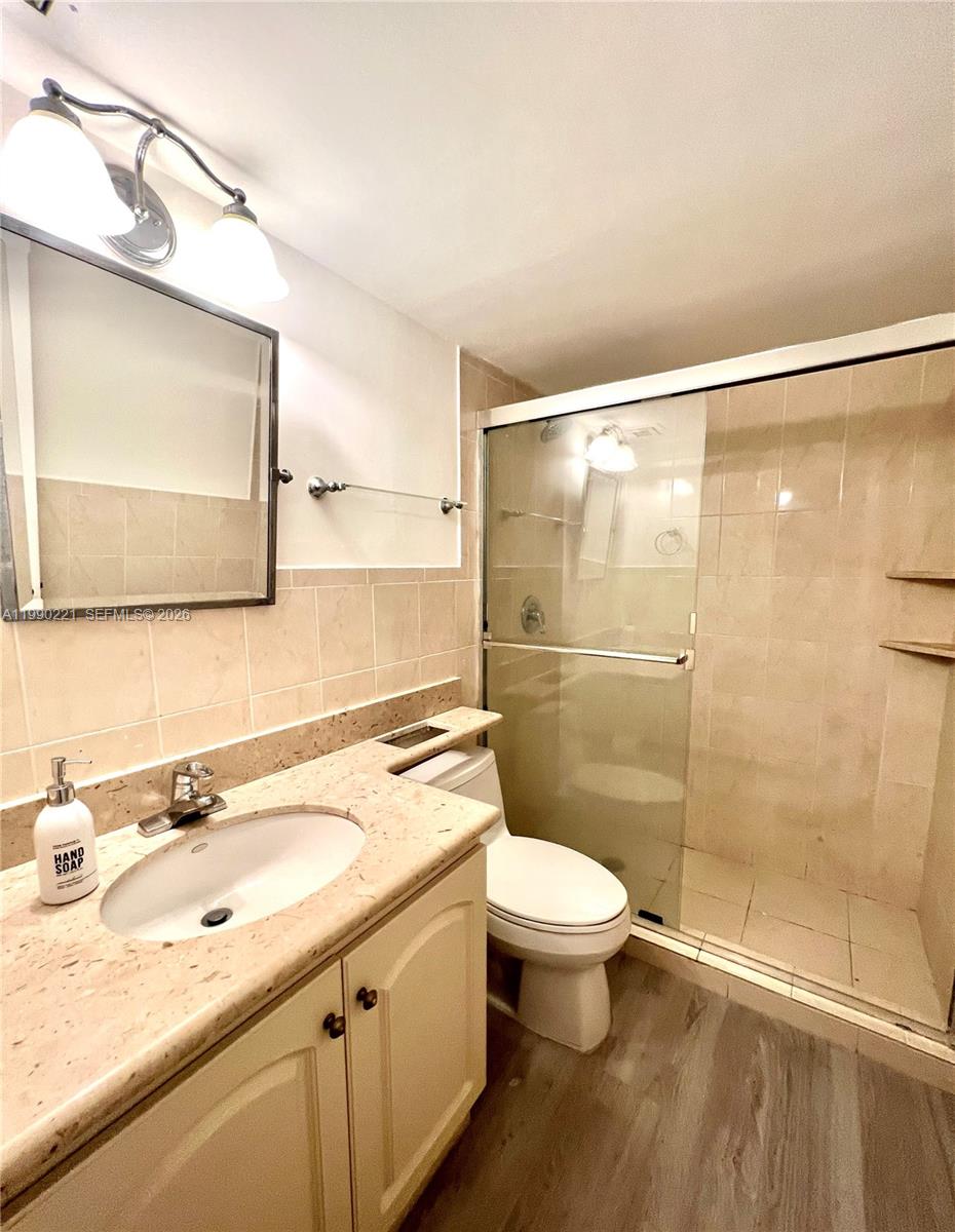 8233 Harding Avenue, Unit 204 Miami Beach, FL 33141 - Photo 12 of 18 a bathroom with a sink toilet and shower