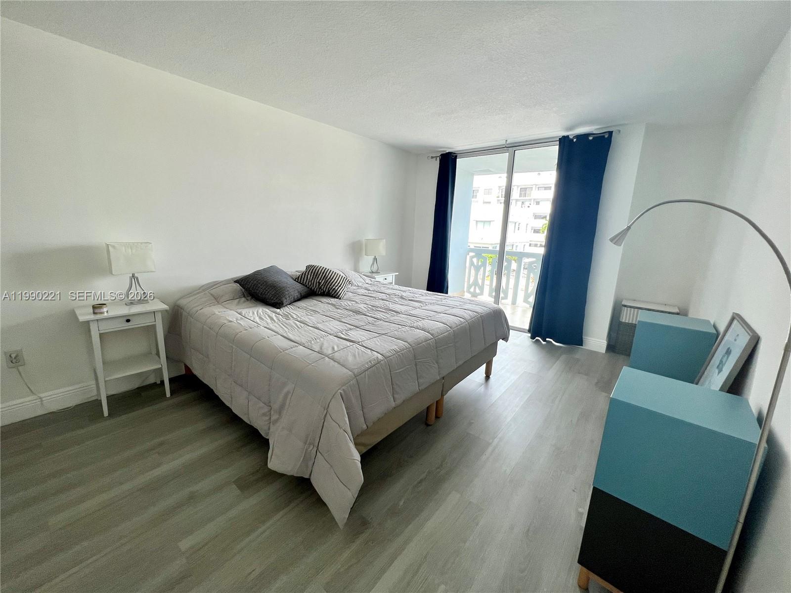 8233 Harding Avenue, Unit 204 Miami Beach, FL 33141 - Photo 16 of 18 a bedroom with a bed and a couch