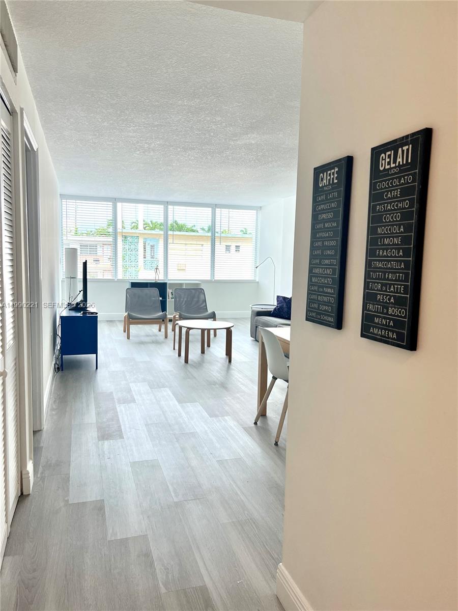 8233 Harding Avenue, Unit 204 Miami Beach, FL 33141 - Photo 3 of 18 a living room with furniture and a large window