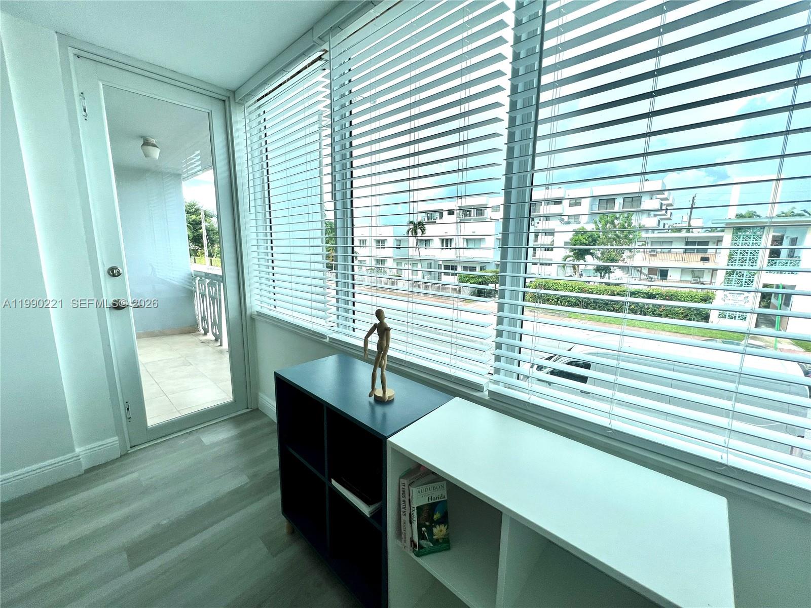 8233 Harding Avenue, Unit 204 Miami Beach, FL 33141 - Photo 6 of 18 a kitchen with a sink and wooden floor
