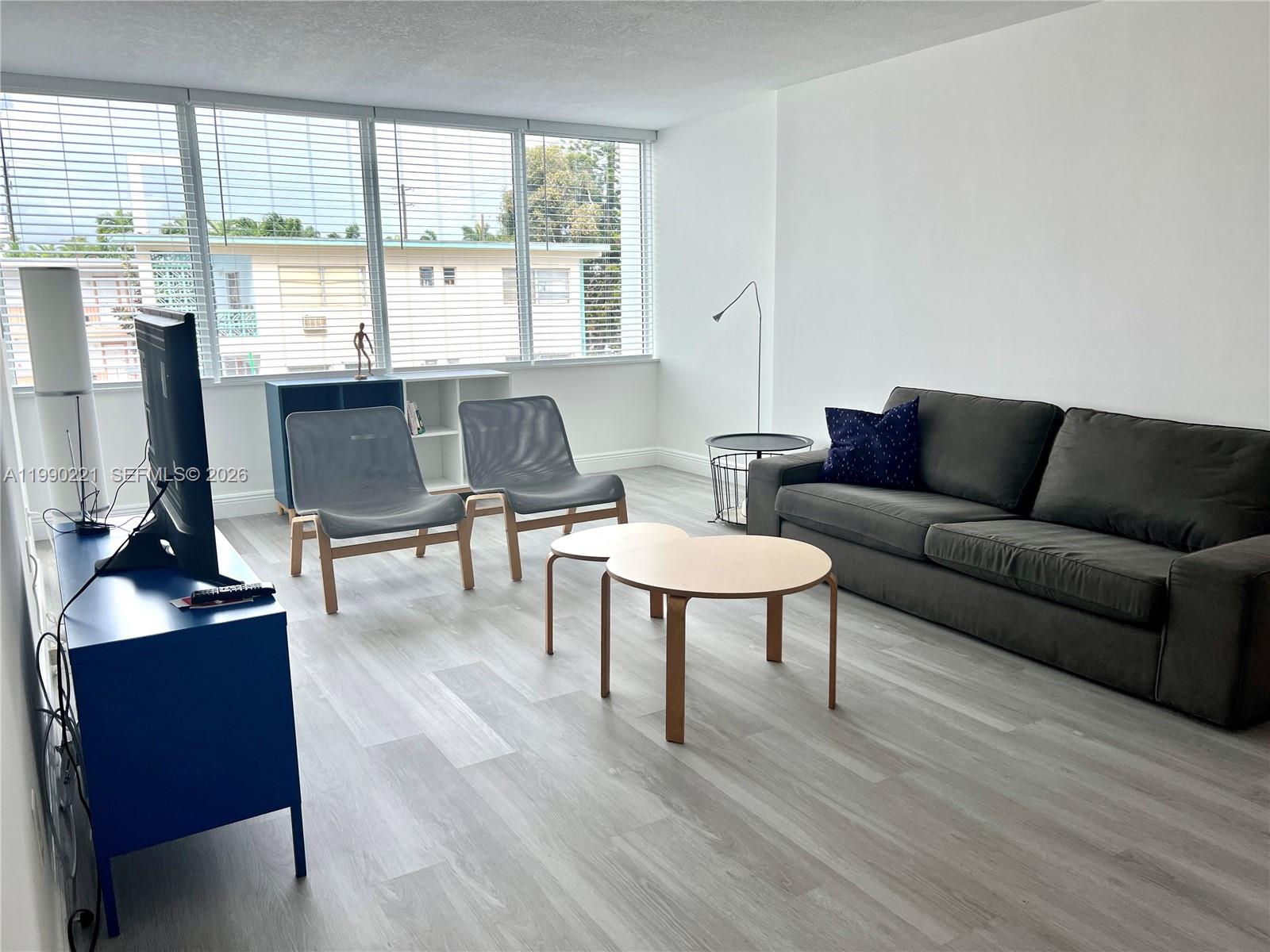 8233 Harding Avenue, Unit 204 Miami Beach, FL 33141 - Photo 7 of 18 a living room with furniture and a table