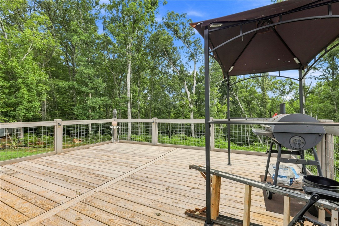525 Shirley Store Road Anderson, SC 29621 - Photo 26 of 46 An expansive wooden deck overlooks dense mature trees, providing a private outdoor retreat.
