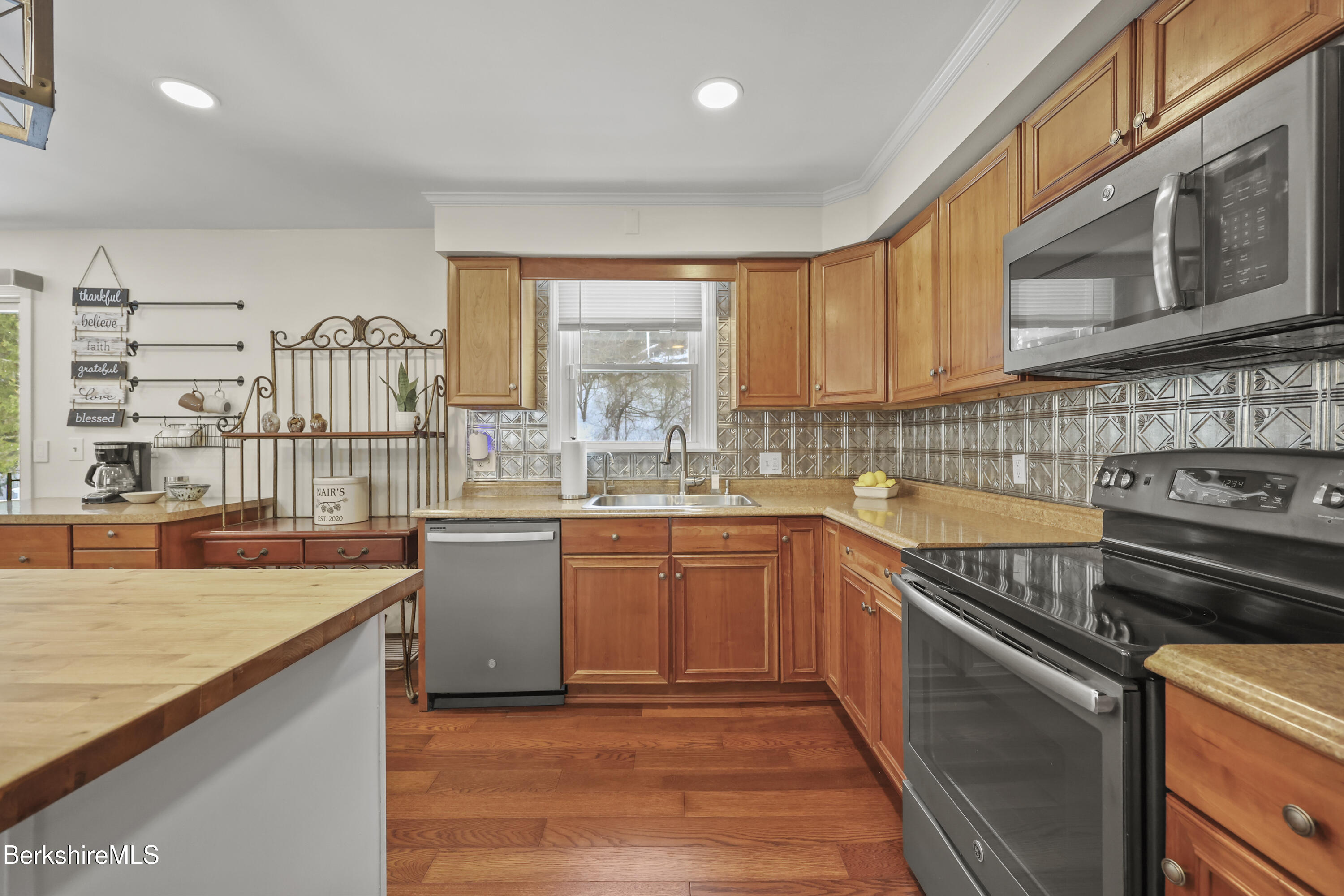 83 Alfred Drive Pittsfield, MA 01201 - Photo 12 of 49 a kitchen with stainless steel appliances granite countertop a sink stove and cabinets