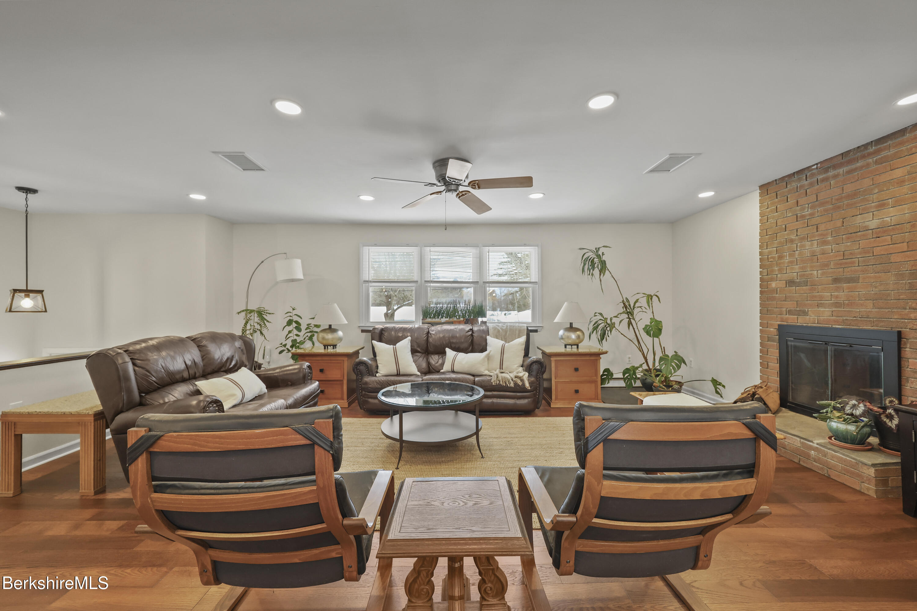 83 Alfred Drive Pittsfield, MA 01201 - Photo 3 of 49 a living room with furniture a fireplace and a chandelier