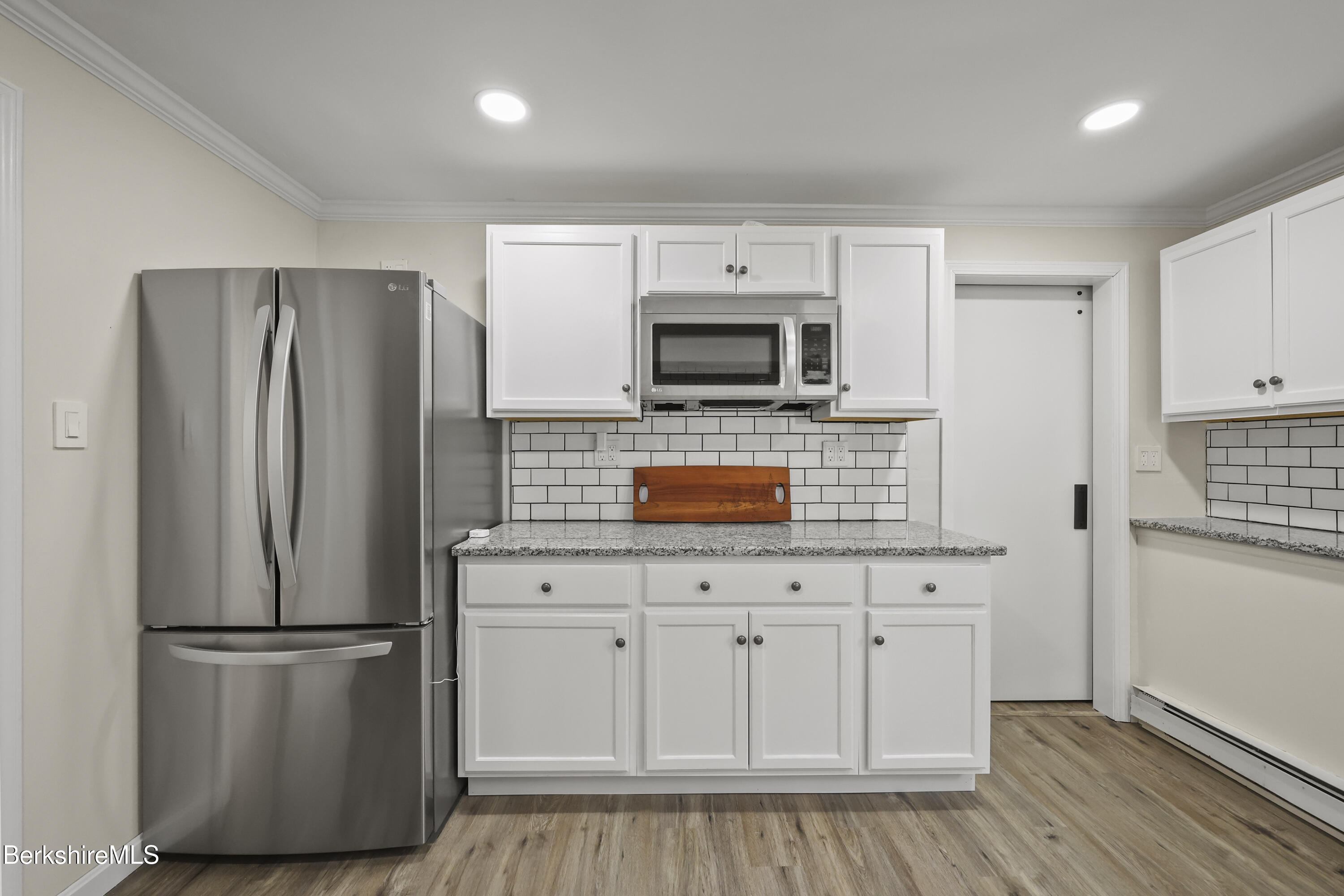 83 Alfred Drive Pittsfield, MA 01201 - Photo 37 of 49 a kitchen with white cabinets white stainless steel appliances and wooden floors