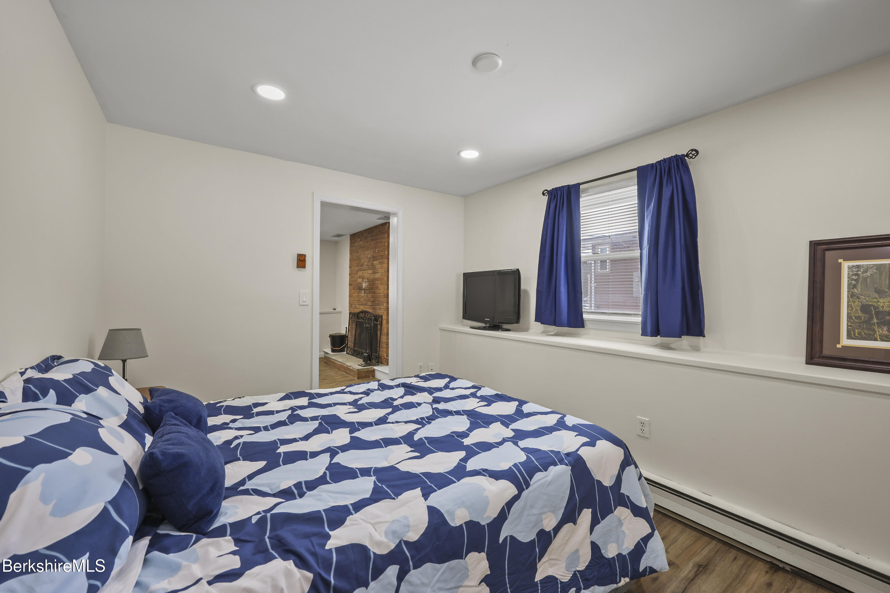83 Alfred Drive Pittsfield, MA 01201 - Photo 45 of 49 a bedroom with a large bed and a flat tv screen on dresser