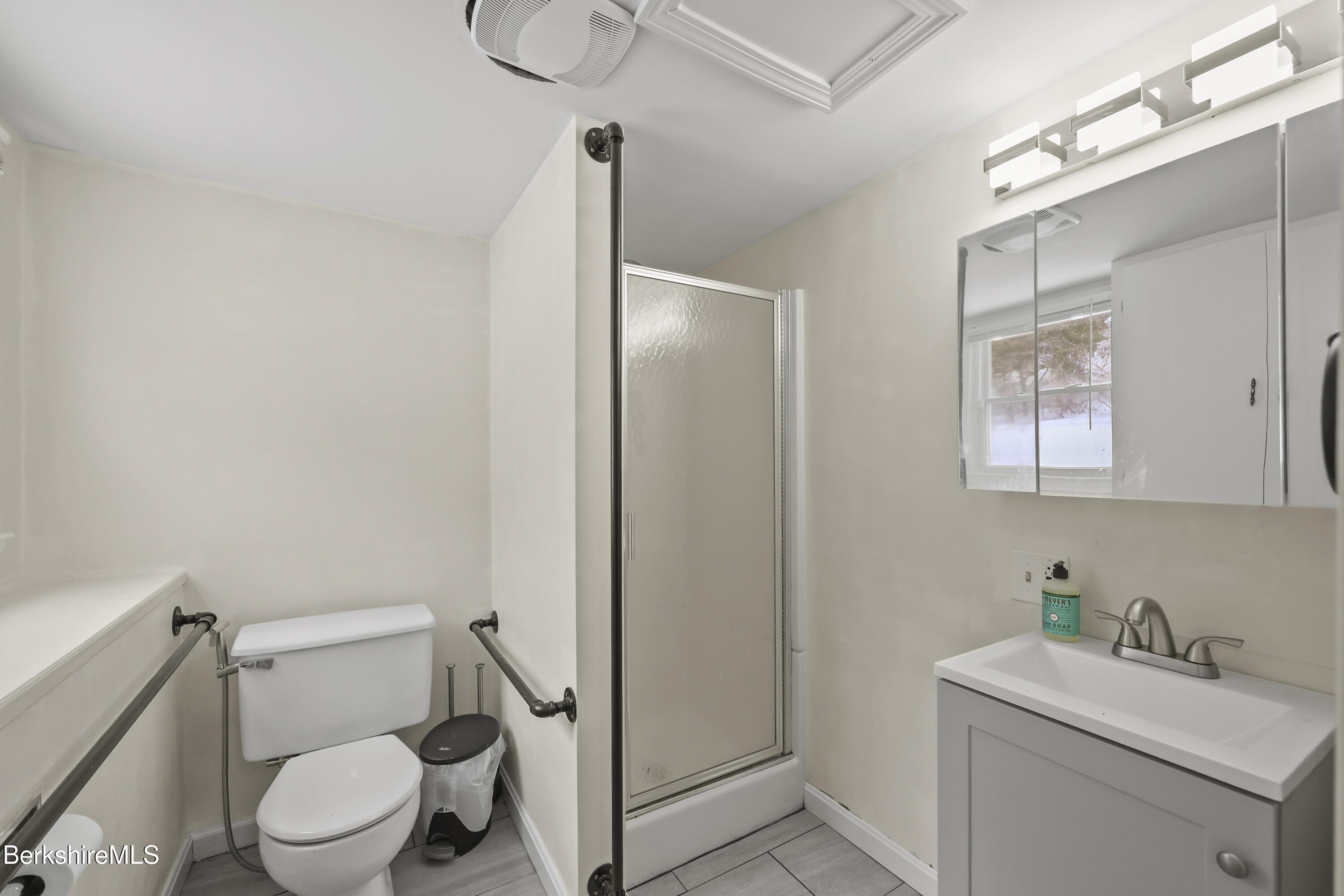 83 Alfred Drive Pittsfield, MA 01201 - Photo 46 of 49 a bathroom with a toilet sink vanity and mirror
