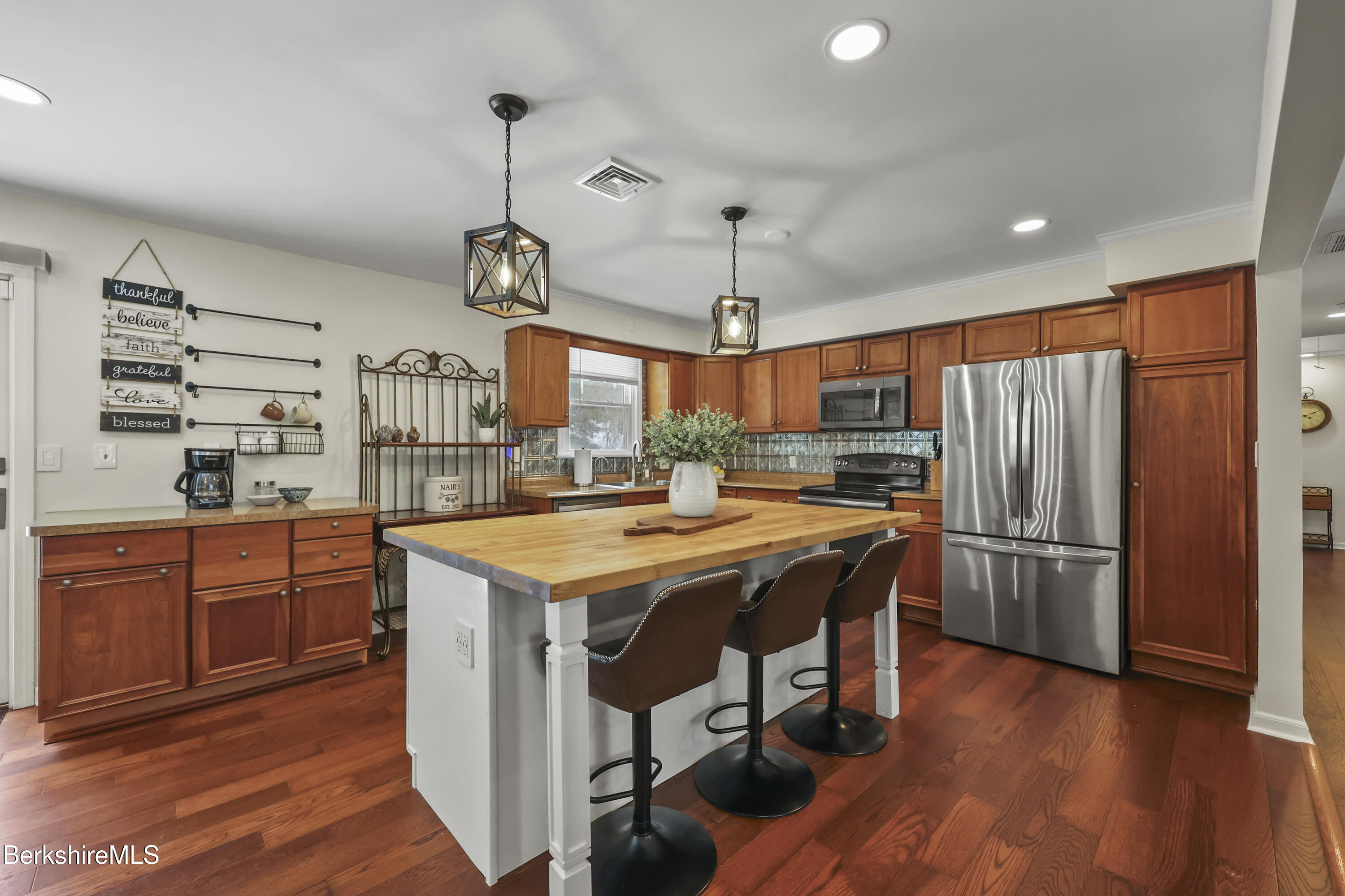 83 Alfred Drive Pittsfield, MA 01201 - Photo 7 of 49 a kitchen with stainless steel appliances granite countertop a refrigerator a sink dishwasher a stove and a dining table with wooden floor