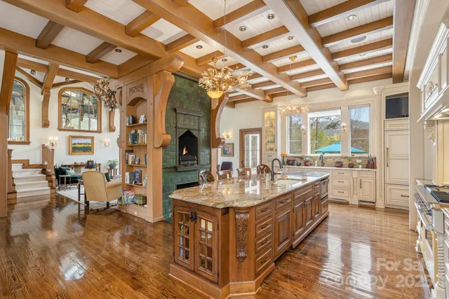 a living room with large mirror and furniture