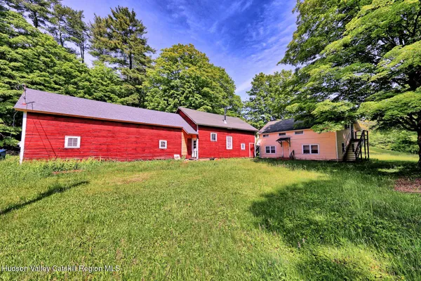 a view of a barn in the middle of a yard