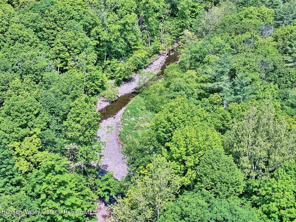 a living room with stainless steel appliances kitchen island granite countertop furniture and wooden floor