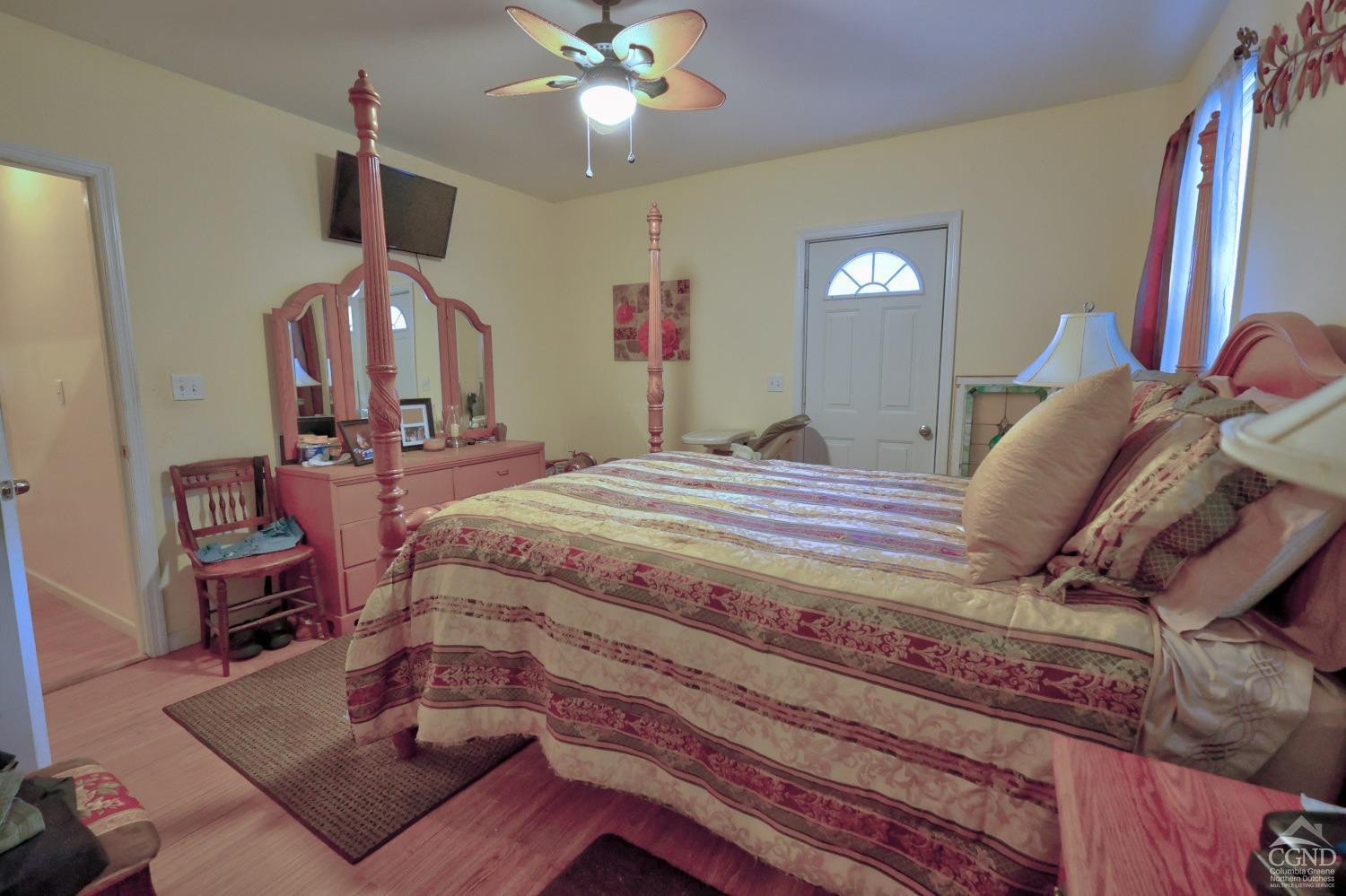 49 County Rte 39 Cairo, NY 12473 - Photo 43 of 114 a bedroom with a bed and dresser with wooden floor