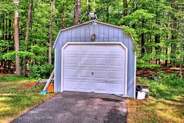 a view of backyard of house with green space