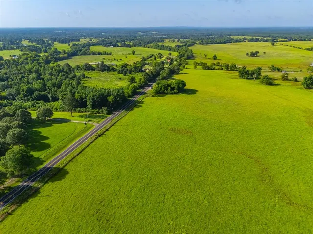 a view of a green field with an ocean