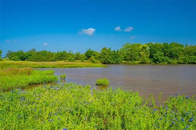 a view of a lake with houses in the back