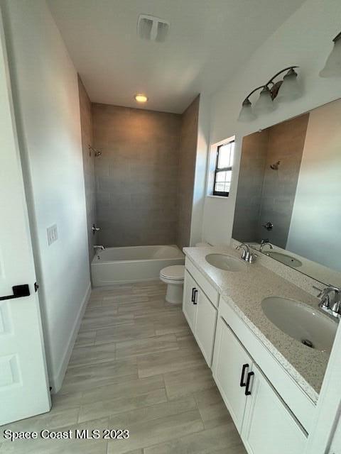 8326 Lyside Drive Melbourne, FL 32940 - Photo 14 of 17 a bathroom with a sink and mirror with toilet