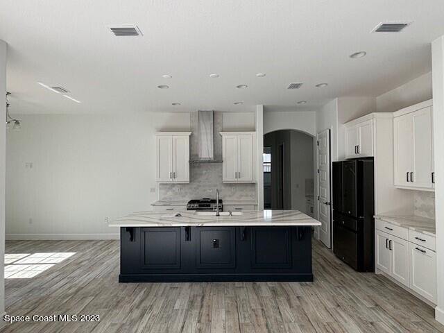 8326 Lyside Drive Melbourne, FL 32940 - Photo 2 of 17 a kitchen with a sink wooden floor and refrigerator
