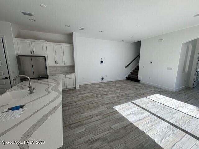 8326 Lyside Drive Melbourne, FL 32940 - Photo 5 of 17 a view of a kitchen with a sink and a refrigerator