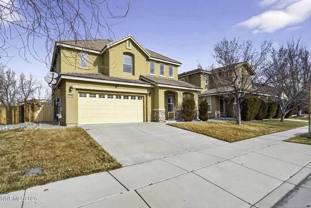 a view of an empty room with wooden floor fireplace and a window