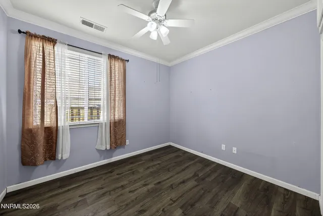 a kitchen with stainless steel appliances granite countertop a sink a stove a refrigerator cabinets and a wooden floor