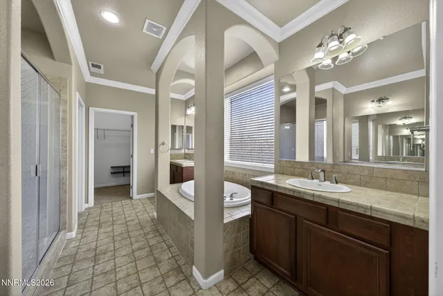 a bathroom with a granite countertop sink a large mirror and a shower