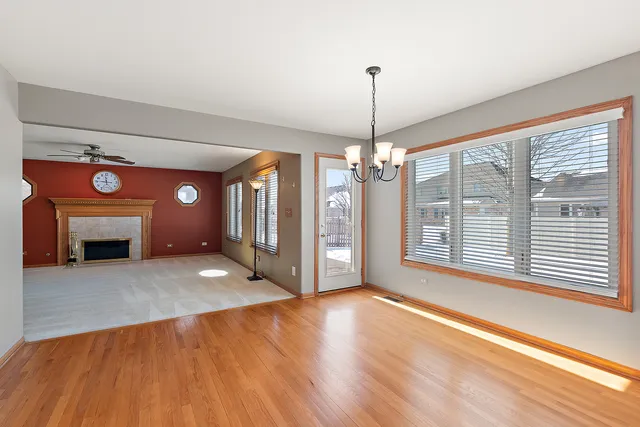 a view of an empty room with a window and fireplace