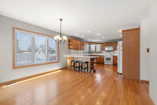 a open kitchen with a table and chairs in it