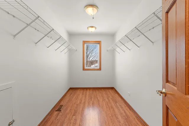 a view of room with window and wooden floor