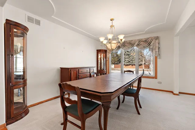 a view of a dining room with furniture and window