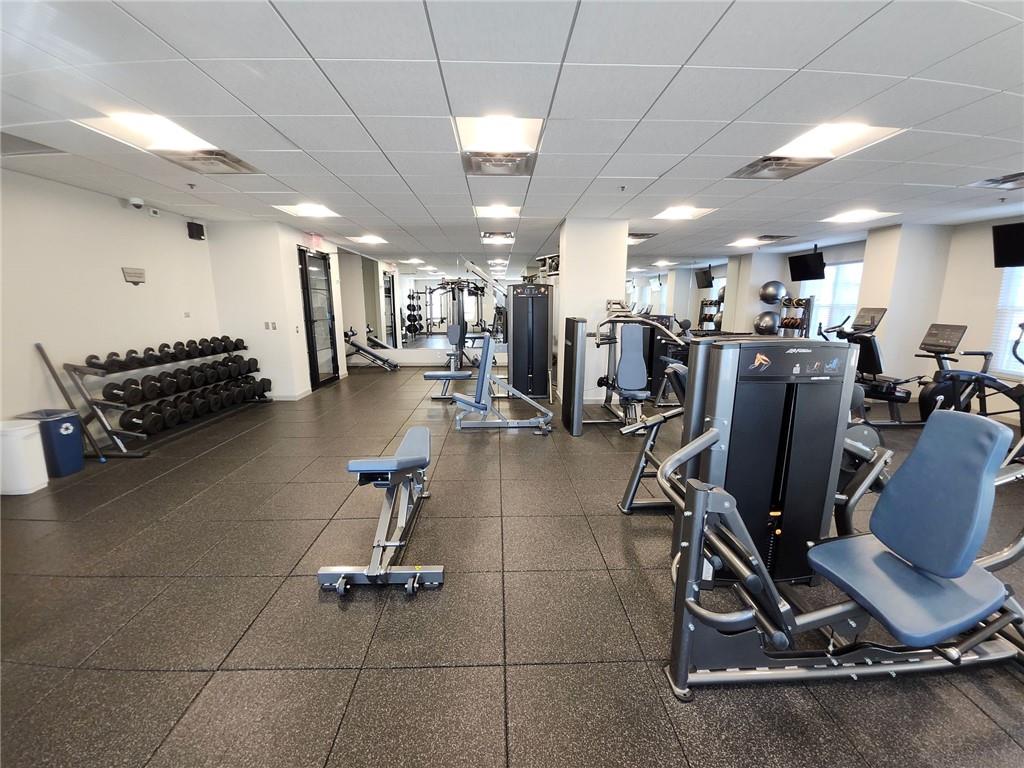 325 East Paces Ferry Road Northeast, Unit 1409 Atlanta, GA 30305 - Photo 12 of 14 a gym room with gym equipment and a large window