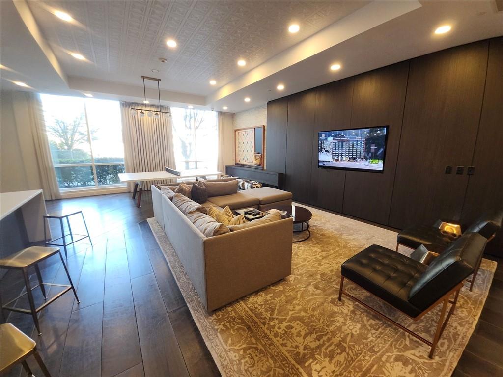 325 East Paces Ferry Road Northeast, Unit 1409 Atlanta, GA 30305 - Photo 13 of 14 a living room with wooden floor and furniture