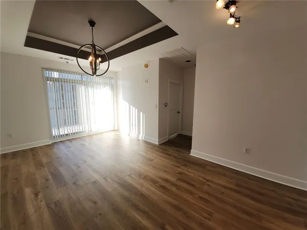 a view of a room with wooden floor