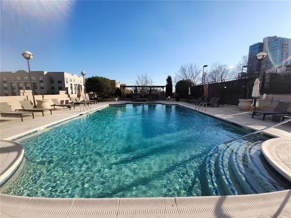a view of a swimming pool and lounge chair
