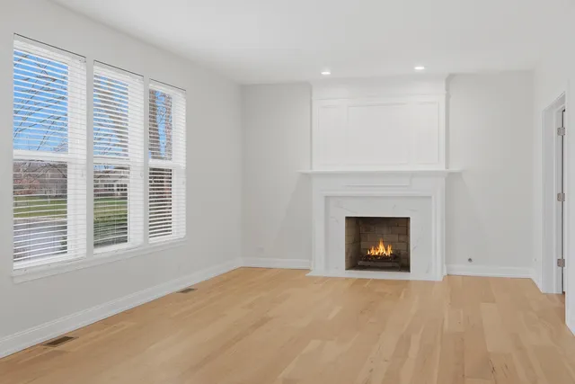 a view of empty room with a fireplace