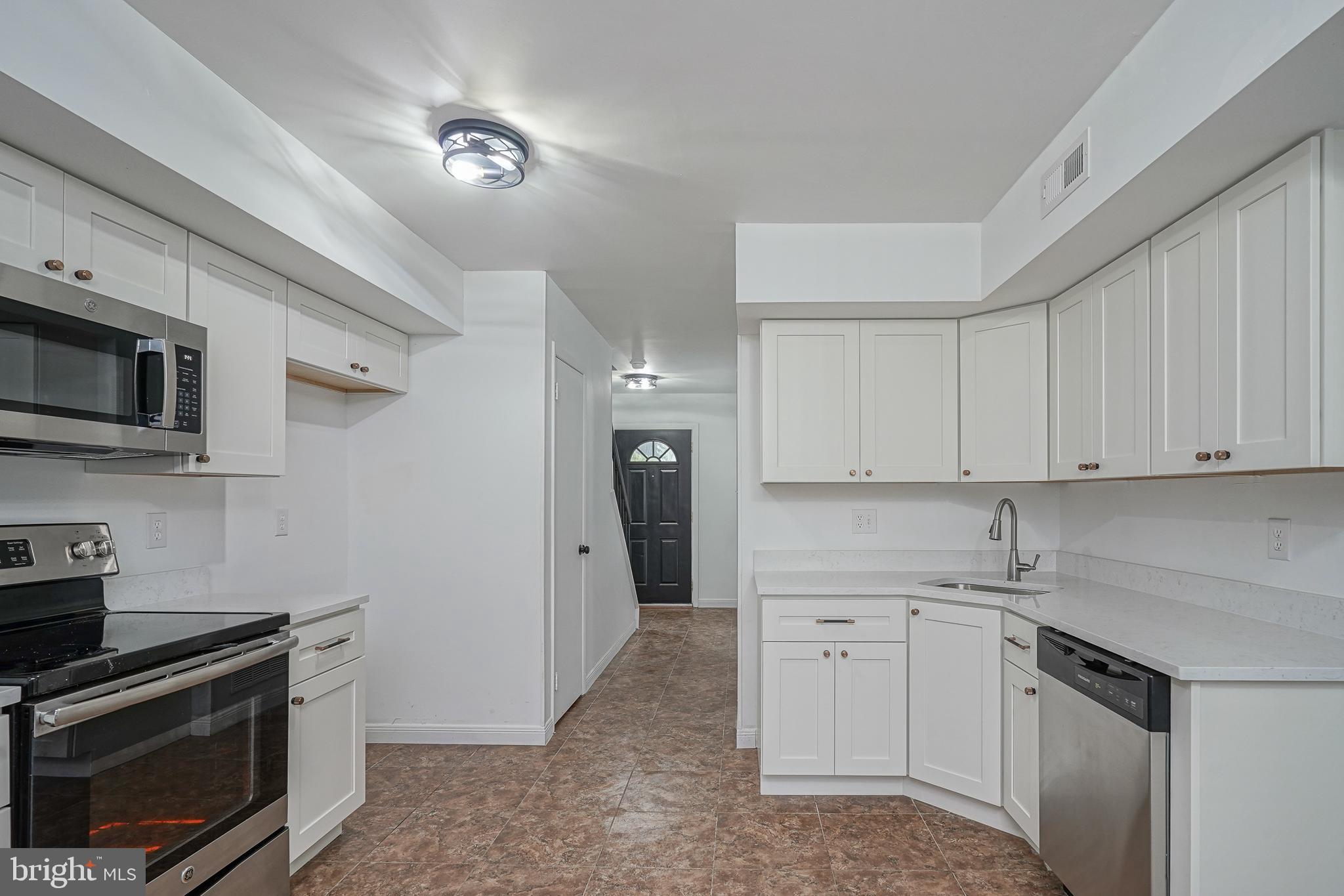 5 Wickham Lane Westampton, NJ 08060 - Photo 11 of 32 a kitchen with a sink stove and microwave