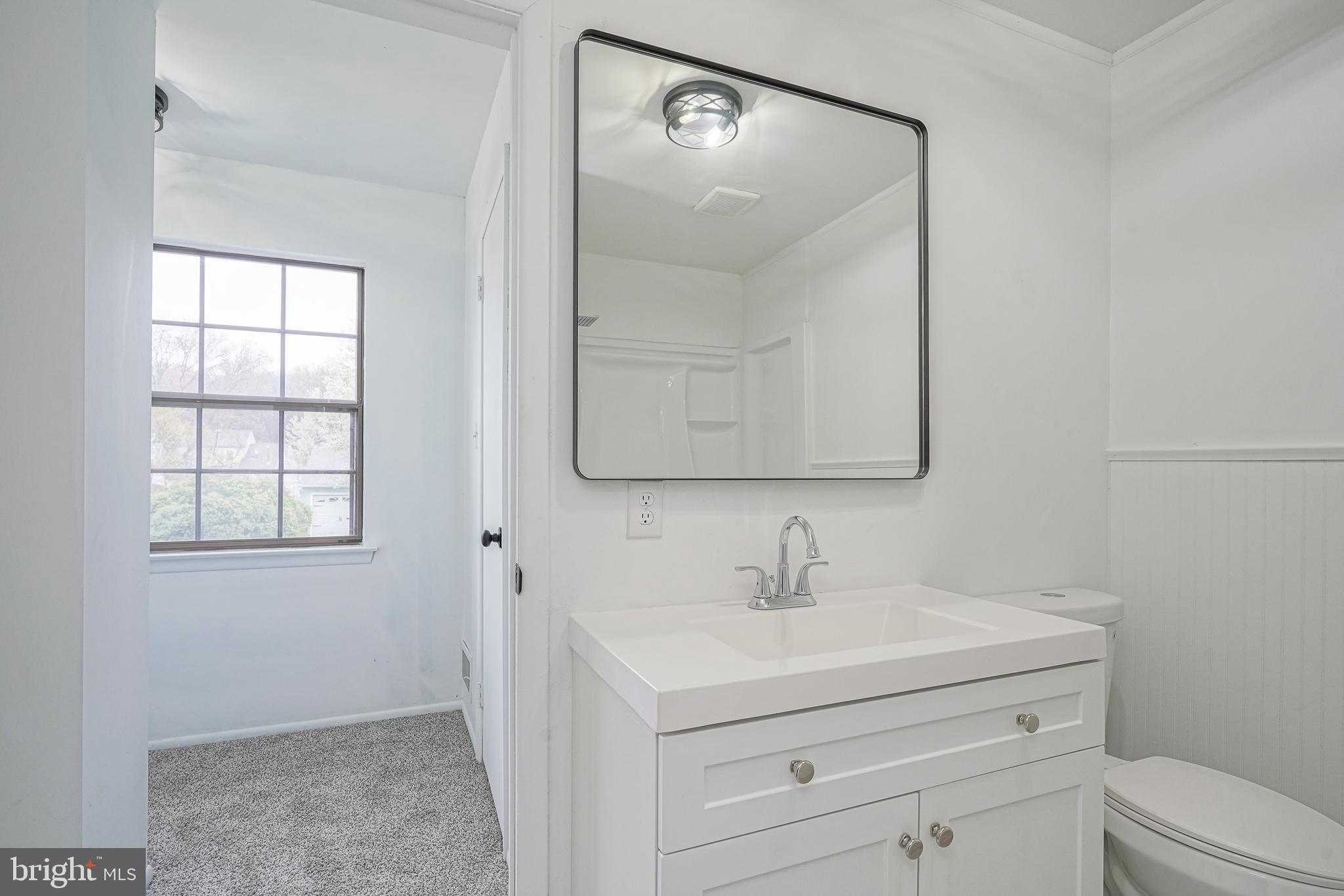 5 Wickham Lane Westampton, NJ 08060 - Photo 21 of 32 a bathroom with a sink a mirror and a toilet