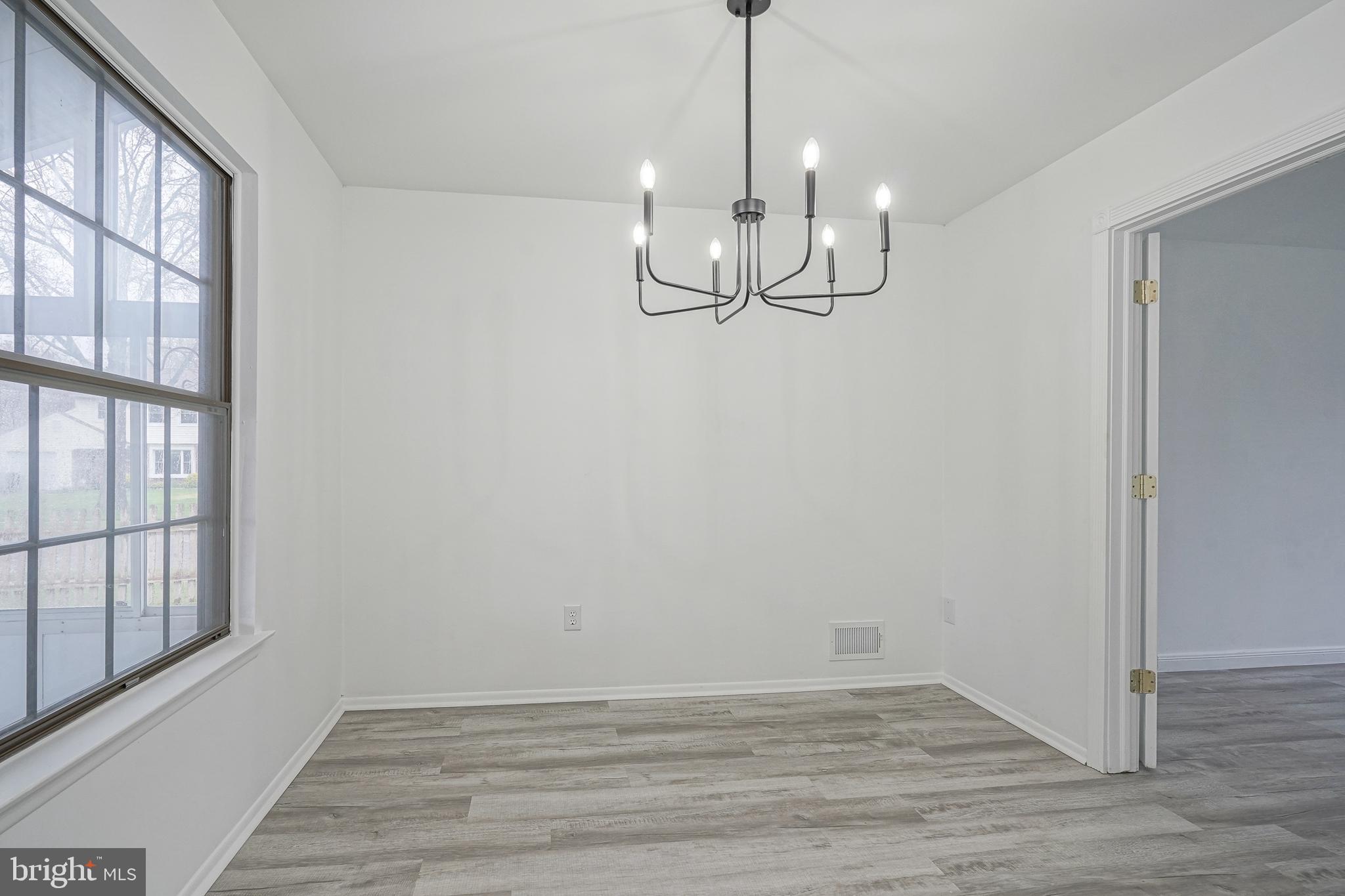 5 Wickham Lane Westampton, NJ 08060 - Photo 9 of 32 a view of empty room with wooden floor and windows