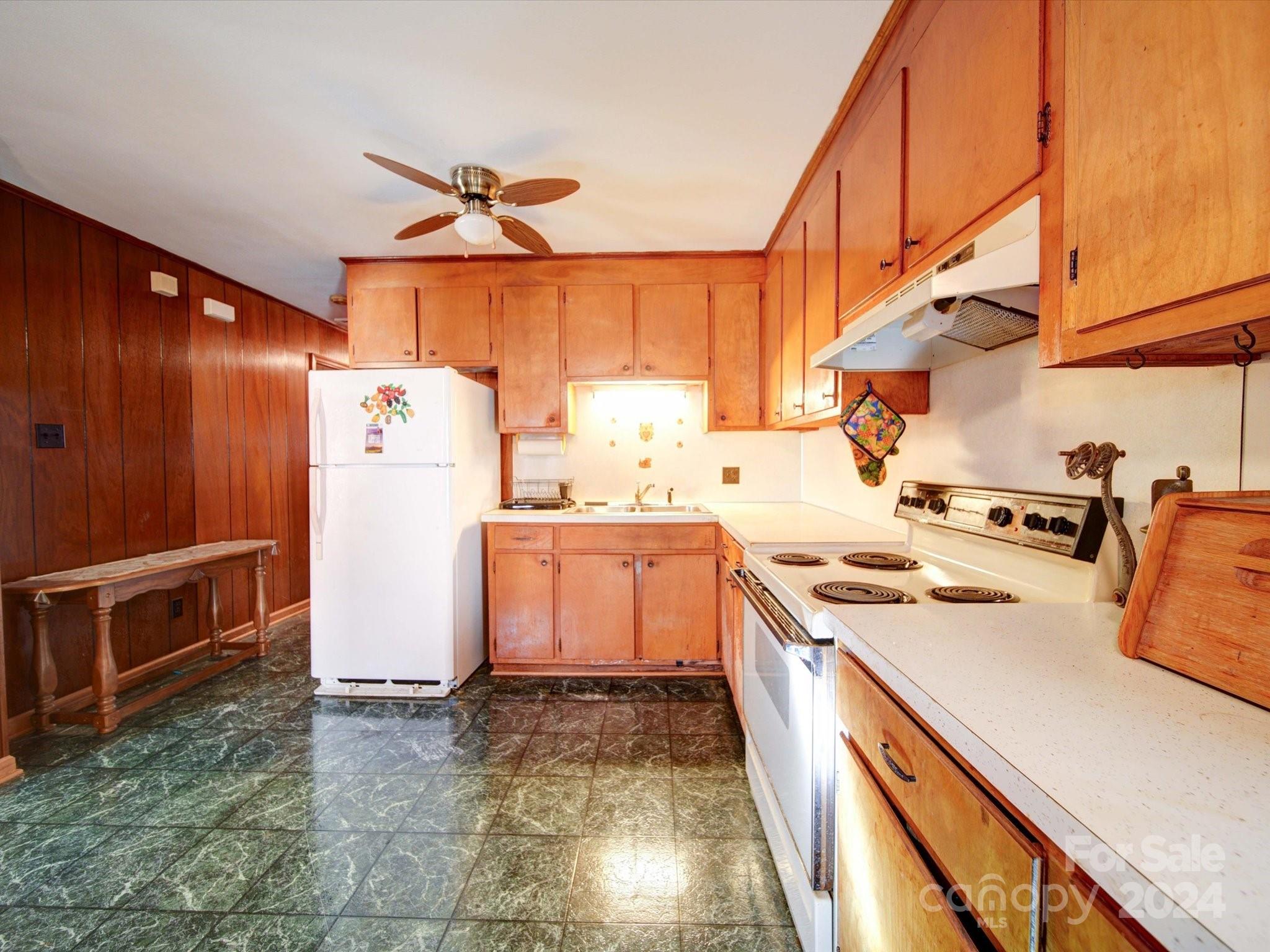 1869 State Rd S-29-584 Lancaster, SC 29720 - Photo 13 of 44 a kitchen with a refrigerator and a stove