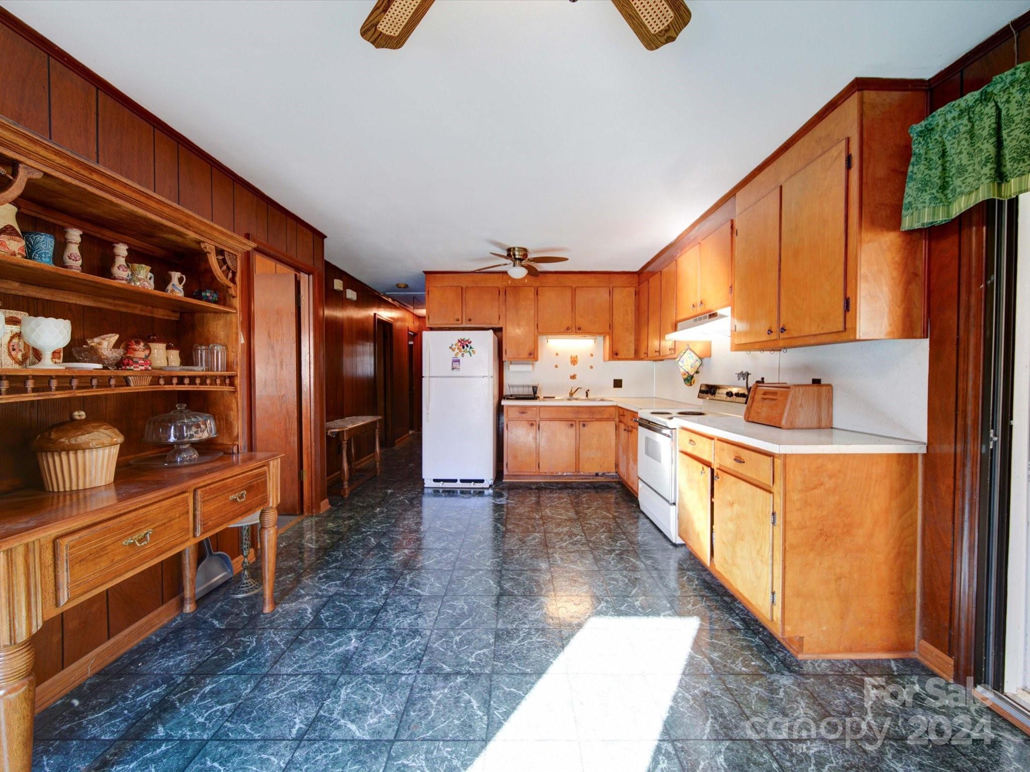 1869 State Rd S-29-584 Lancaster, SC 29720 - Photo 17 of 44 a kitchen with stainless steel appliances kitchen island granite countertop a refrigerator and stove top oven