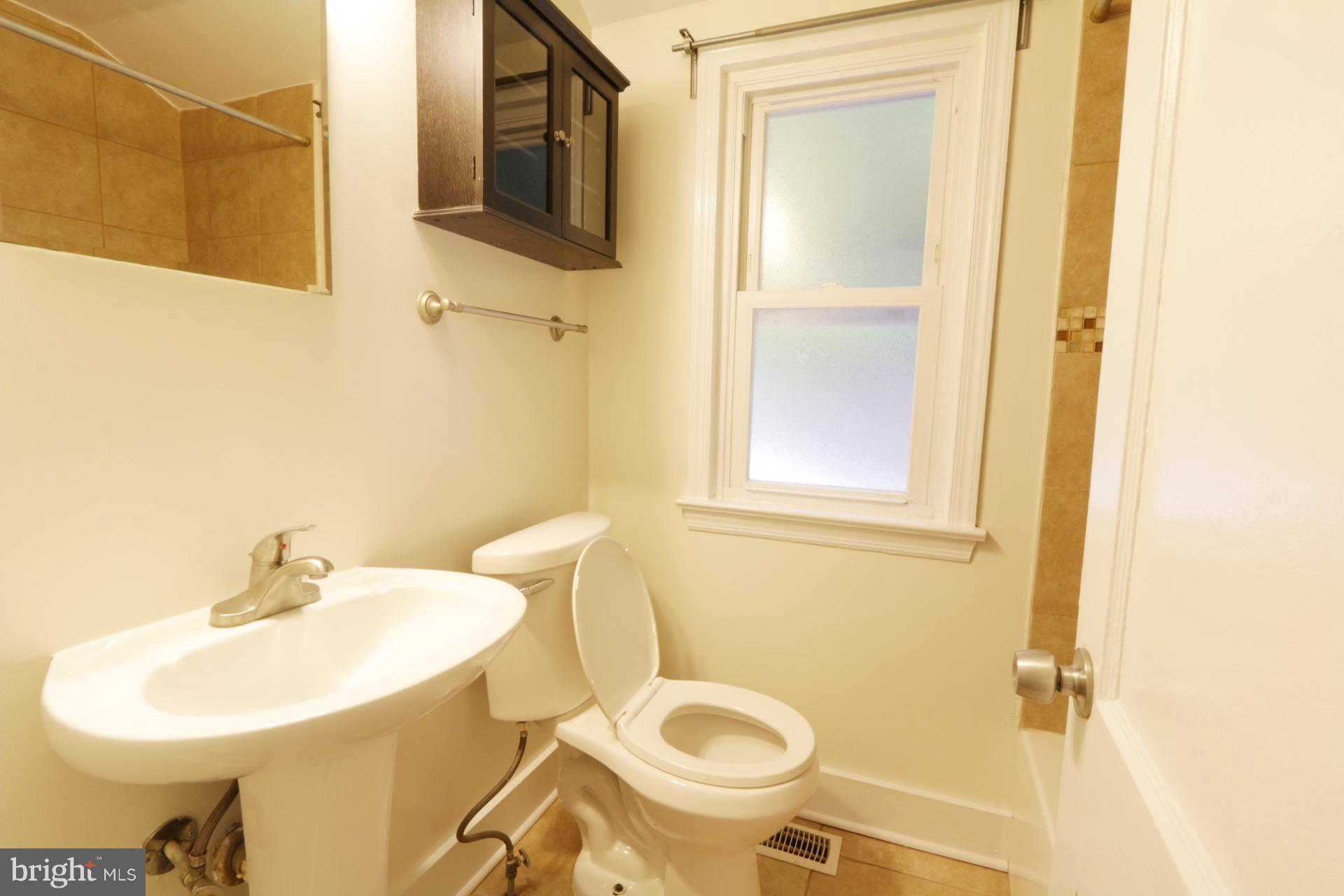 3723 South Kemper Road Arlington, VA 22206 - Photo 12 of 15 a bathroom with a sink a toilet and a mirror